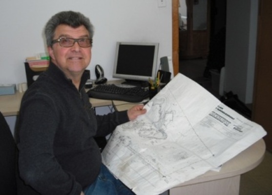 Jack Gentile from Pauls Landscaping sitting in his office reading plans