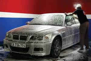 Employee washing a car at Homa Car Wash