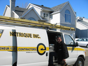 The electrician Domenic Iasenza on the job standing by his white truck